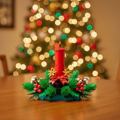 A Christmas Advent wreath set built from LEGO-style bricks, featuring a tall red candle, green pine and fir branches, red berries, gold ornaments, and a red bow on a white background.